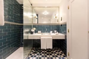 a bathroom with a sink and a mirror at The Albatroz Hotel in Cascais
