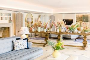 a living room with a blue couch and a table with plants at The Albatroz Hotel in Cascais
