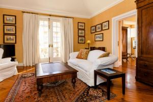 a living room with a white couch and a coffee table at The Albatroz Hotel in Cascais