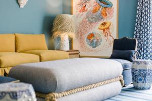 a living room with a couch and a ottoman at The Albatroz Hotel in Cascais