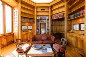 a living room with a couch and a table and chairs at The Albatroz Hotel in Cascais