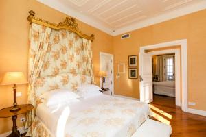 a bedroom with a large bed with a floral headboard at The Albatroz Hotel in Cascais