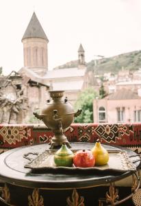 a table with some fruit on top of it at Mariam R in Tbilisi City