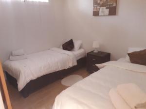 a room with two beds with white sheets at Ric Rent in Rojales