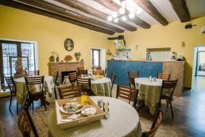 a restaurant with tables and chairs and a fireplace at Mariam R in Tbilisi City