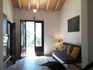 a living room with a couch and a sliding glass door at CASA 2 PINS in Porto Cristo