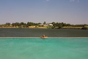 a person swimming in a body of water at Herdade dos Grous in Albernoa