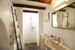 a bathroom with a sink and a mirror and a tub at La Porta Rossa in Stromboli