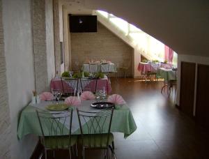 a room with tables and chairs with pink tablecloths at Ivan Da Mariya Guest House in Lazarevskoye