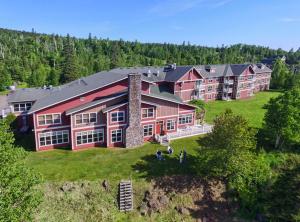 an aerial view of a large house with people in front of it at Cove Point Lodge in Beaver Bay