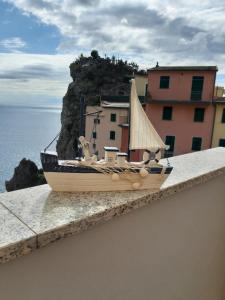 a toy boat sitting on the ledge of a building at Alex Room in Manarola