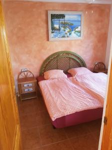 a bedroom with a bed and a picture on the wall at Ferienhaus SUNSHINE Torrevieja/Spanien in Orihuela Costa +10 photos