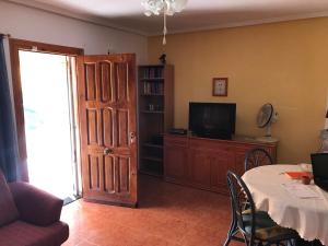 a living room with a tv and a table with a table at Ferienhaus SUNSHINE Torrevieja/Spanien in Orihuela Costa