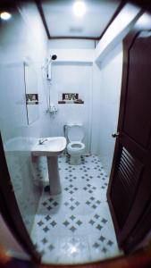 a bathroom with a white toilet and a sink at SD View Hotel in Vang Vieng