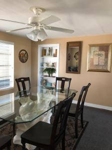 a dining room with a glass table and chairs at The Surf Beach Motel in Amelia Island