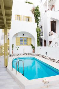 a villa with a swimming pool in front of a house at Sunny Days in Fira