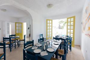 a dining room filled with tables and chairs at Sunny Days in Fira