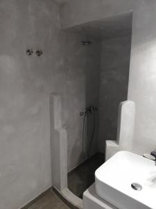 a white bathroom with a sink and a toilet at Bahia in Hydra
