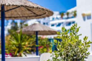 a couple of umbrellas sitting on a beach at Romantika in Platis Gialos