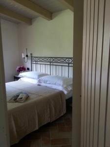 a bedroom with a white bed and white walls at La Locanda Della Chiocciola in Orte