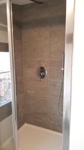 a shower with a shower head in a bathroom at La casa degli ulivi in Lierna