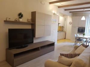 a living room with a flat screen tv on a entertainment center at Appartamento il Riccio in Portoferraio