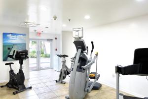 a gym with treadmills and exercise bikes in a room at The Grand Caymanian Resort in George Town
