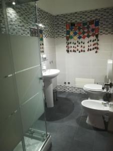 a bathroom with two toilets and a glass shower at Ila in Fiera in Rome
