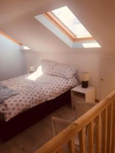 a bedroom with a bed and a skylight at Teach Beag Cois Tra in Miltown Malbay