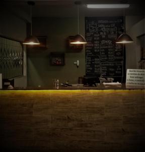 a bar with a chalkboard on the wall of a restaurant at Vitor Moreira pousada campo verde ltda in São João del Rei