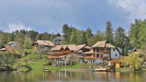 un gruppo di case su una collina vicino a un lago di Hotel Weihrerhof a Soprabolzano