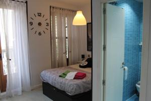 a bedroom with a bed and a mirror at Balcony Apartment Malasaña in Madrid