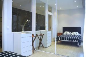 a mirror in a room with a bed and a dresser at APARTAMENTO CENTRICO in Santander