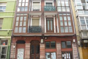 a tall building with many windows on a city street at APARTAMENTO CENTRICO in Santander