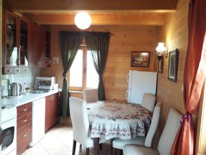 a kitchen with a table and chairs and a refrigerator at Sunnyside in Žabljak