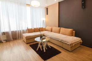 a living room with a couch and a table at Apartment-Hotel Panorama in Dnipro