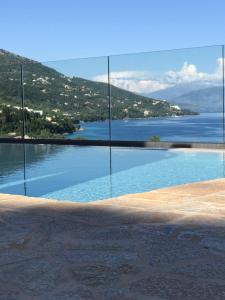 a swimming pool with a view of the water at Villa Renata Gold in Barbati