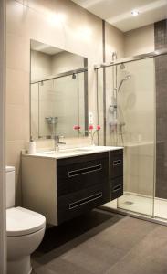 a bathroom with a sink and a toilet and a shower at Central, Spacious and Authentic Family Apartment in Donostia-San Sebastián