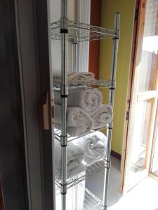 a stack of towels on a towel rack in a room at A casa di Nanè in Marina di Ragusa