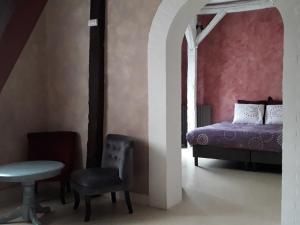 a bedroom with a bed and a chair and a table at Moulin Béchereau in Mer +31 photos