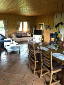 a living room with a table and chairs and a couch at Hof Keske in Peissen