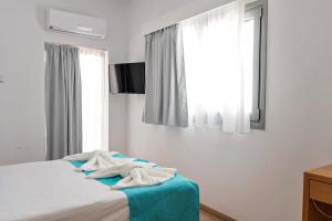 Voodi või voodid majutusasutuse Pyramos Hotel toas