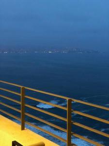 a view of the ocean from a pier with a fence at Apartamento Piso 19 Reñaca Vista al Mar in Viña del Mar