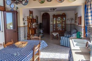 a kitchen and living room with a table and a couch at Villa Azzurra con vista sul mare in San Vito lo Capo