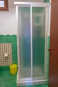 a shower with a glass door in a bathroom at Villa Verde con vista sul mare in San Vito lo Capo