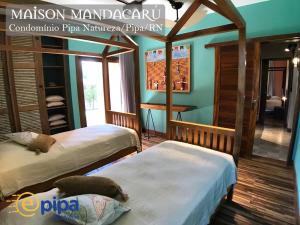Una cama o camas en una habitación de Maison Mandacaru - Pipa Natureza