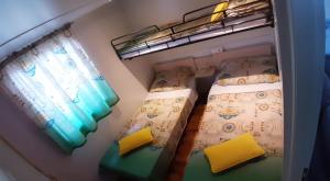 two bunk beds in a small room with a window at Mobile home Lučan in Drage +33 photos