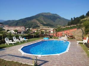 a swimming pool in a yard with mountains in the background at La Hacienda Del Campo in Potes