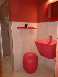 a bathroom with a red sink and a red stool at Casa Rural Yeguada Jimenez Latorre in Fernancaballero +22 photos