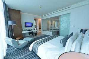 a hotel room with a large bed and a desk at Ramee Grand Hotel And Spa in Manama